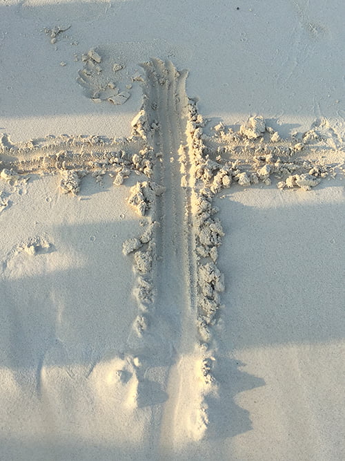 A sacred symbol etched into the warm sand, resembling a beloved home.