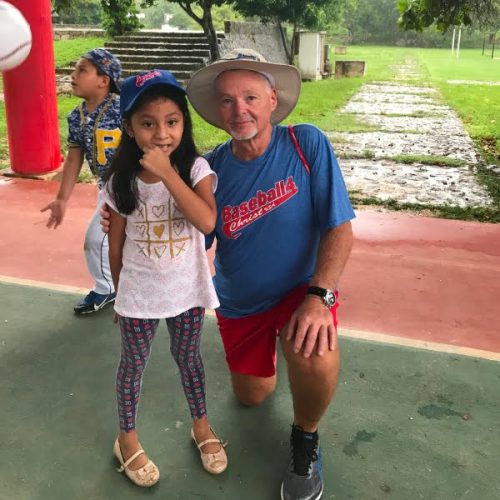 A young girl posing for a photo with an older man.