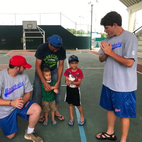 A group of people on a basketball court.